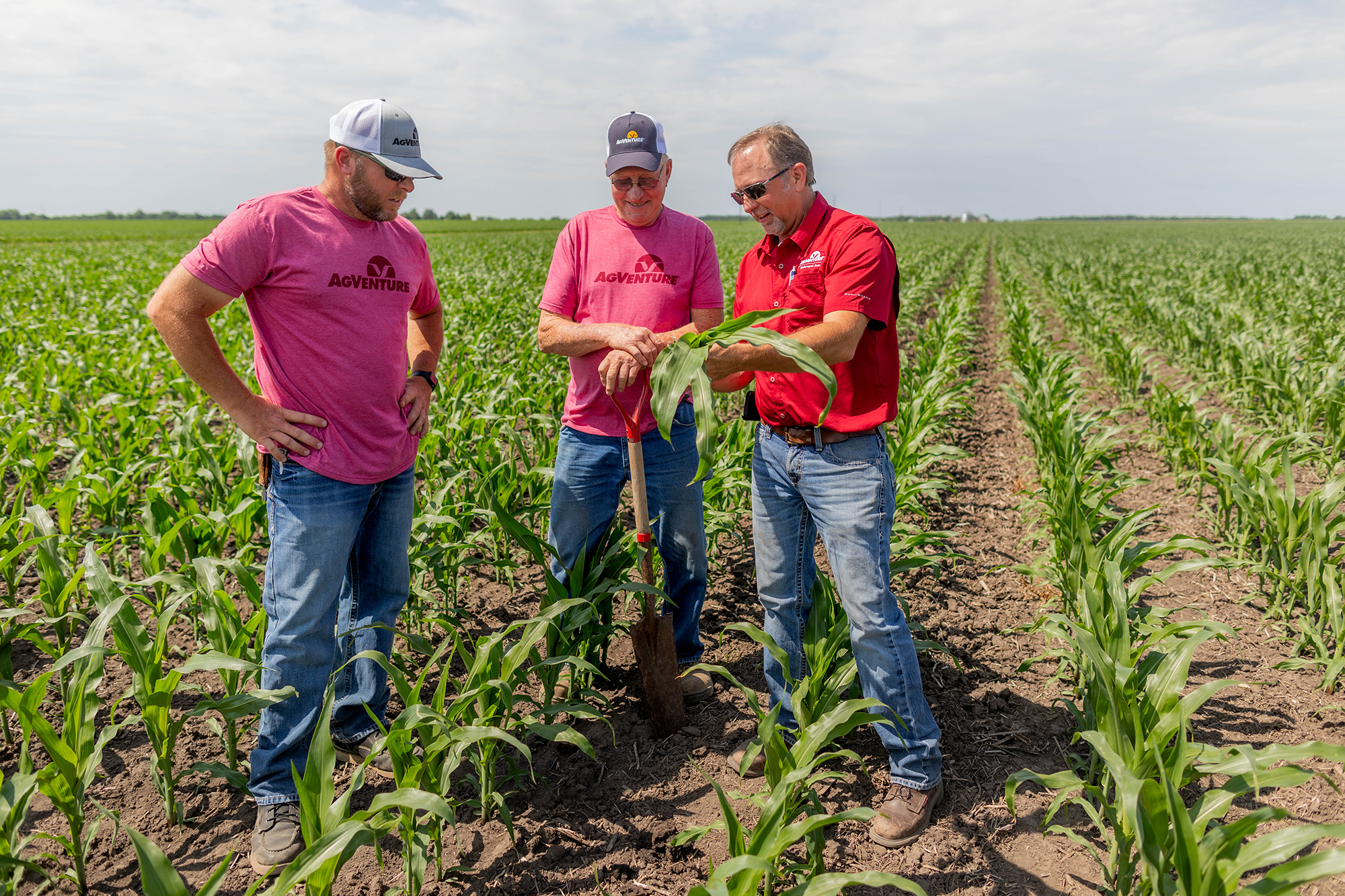 dealers and farmer standing in field